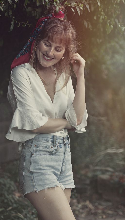 Portrait in a white shirt and headscarf among trees